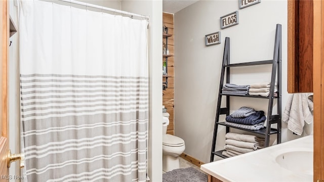 bathroom featuring vanity and toilet