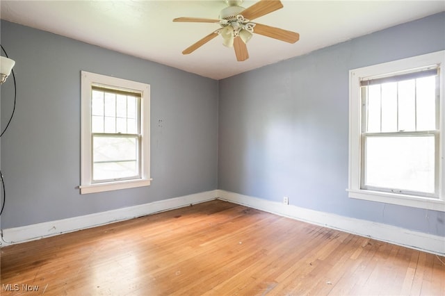 empty room with ceiling fan and light wood-type flooring