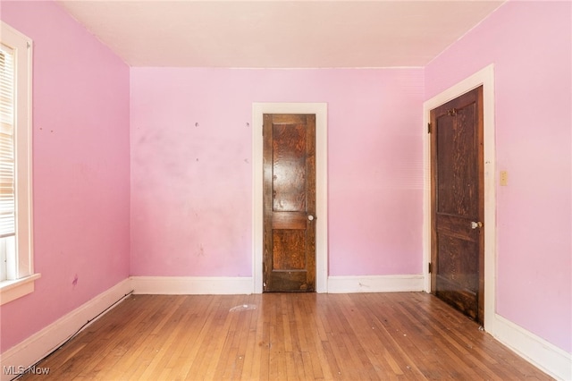 unfurnished room featuring hardwood / wood-style floors