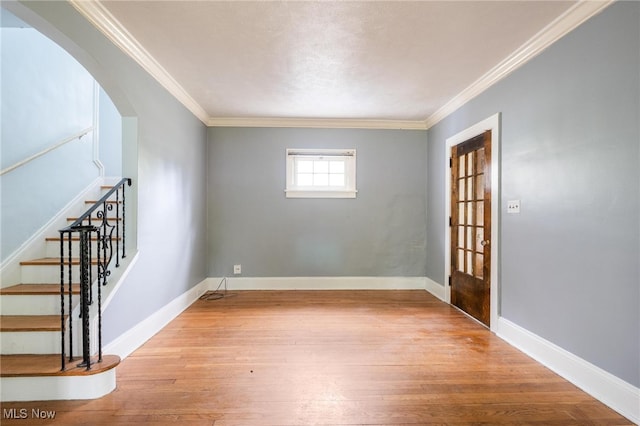 foyer entrance featuring light hardwood / wood-style floors and ornamental molding