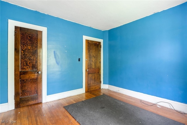 spare room with wood-type flooring