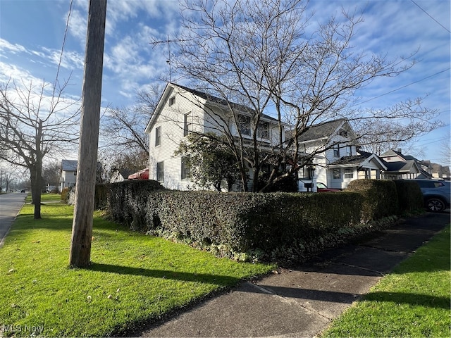 view of side of home featuring a lawn