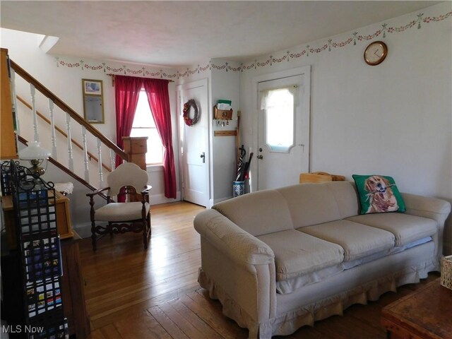 living area with wood-type flooring and stairway