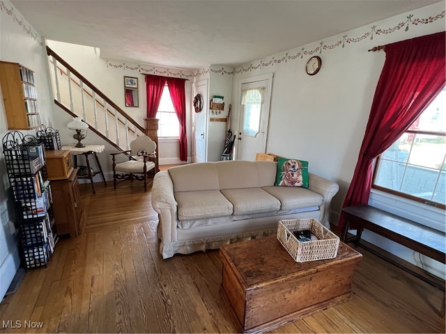 living room with hardwood / wood-style flooring and a healthy amount of sunlight