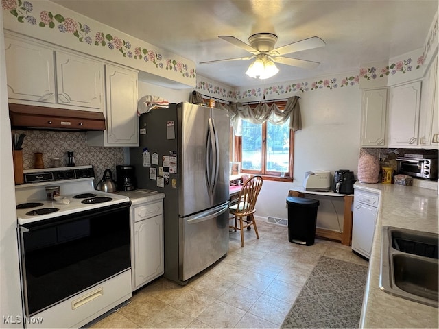 kitchen featuring backsplash, white appliances, ceiling fan, sink, and white cabinets