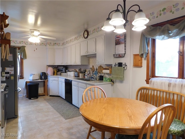 kitchen featuring stainless steel fridge, backsplash, ceiling fan with notable chandelier, sink, and white cabinets