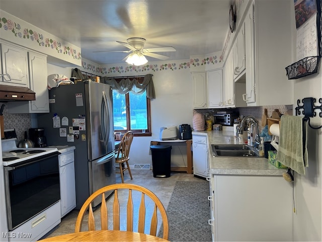 kitchen featuring white electric range, sink, ceiling fan, tasteful backsplash, and white cabinetry