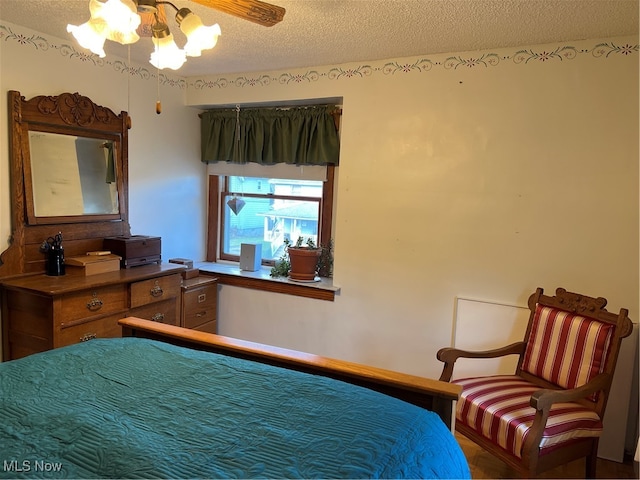 bedroom with a textured ceiling, a closet, and ceiling fan