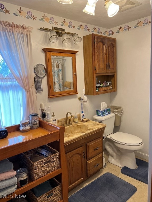 bathroom featuring tile patterned floors, vanity, and toilet