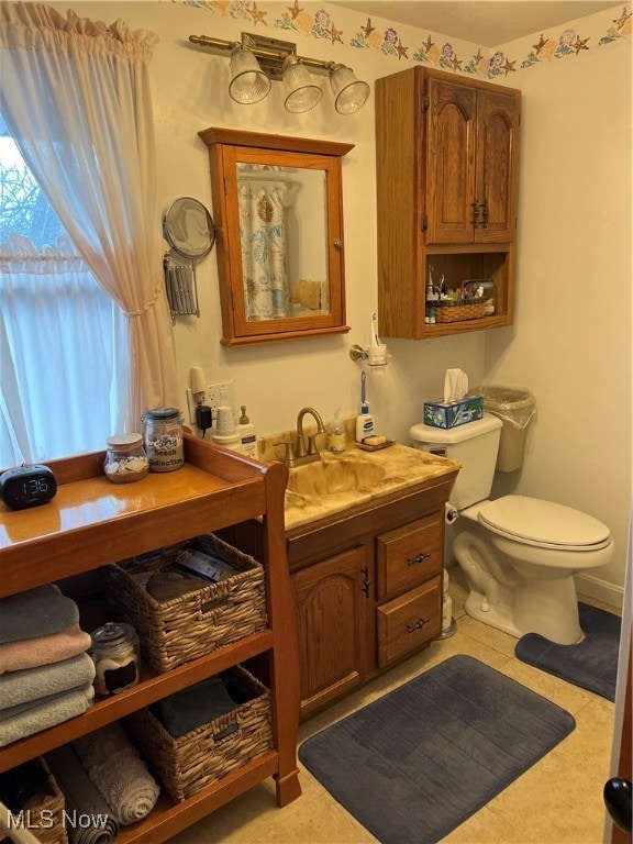 bathroom with tile patterned floors, vanity, and toilet