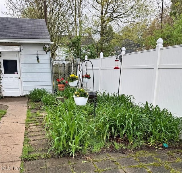 view of yard with fence and an outbuilding