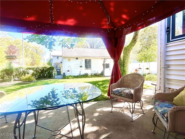 view of patio / terrace with fence and an outdoor structure