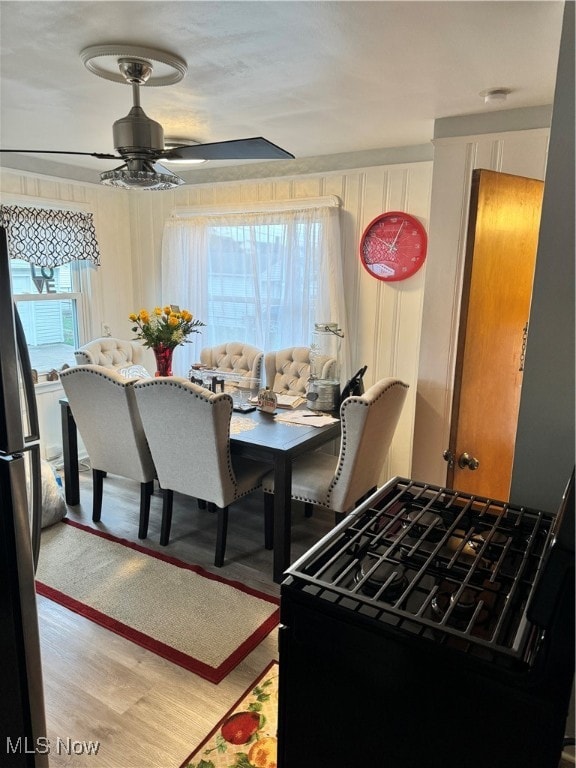 dining area with ceiling fan and light hardwood / wood-style flooring