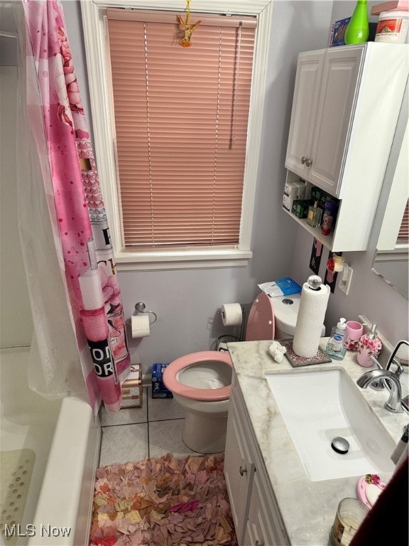 bathroom featuring tile patterned floors, vanity, and toilet