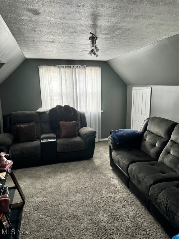 carpeted living room featuring a textured ceiling and vaulted ceiling