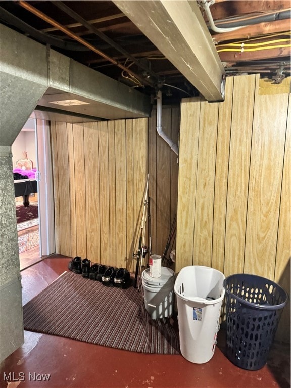 basement featuring wood walls