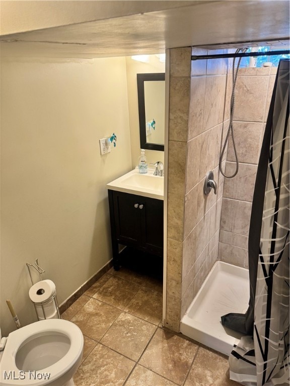 bathroom featuring tile patterned flooring, a shower with curtain, vanity, and toilet