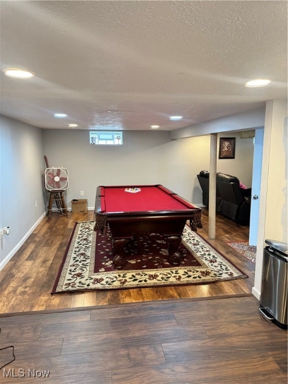 game room featuring a textured ceiling, dark hardwood / wood-style floors, and pool table