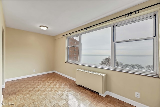 empty room featuring light parquet floors and radiator