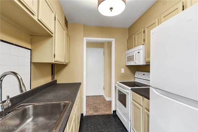 kitchen featuring cream cabinetry, backsplash, white appliances, and sink