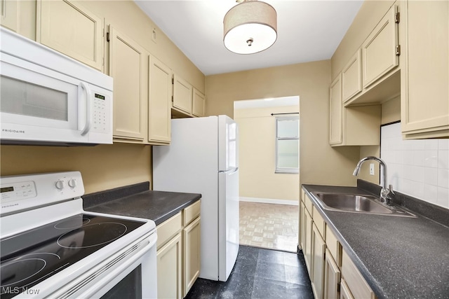 kitchen with decorative backsplash, white appliances, sink, and cream cabinets