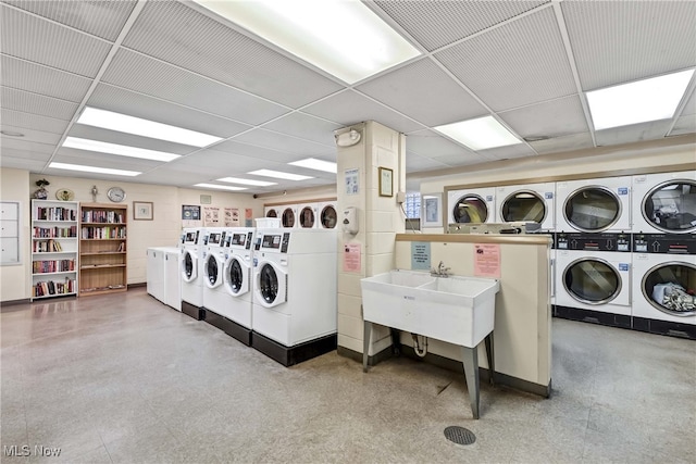 washroom featuring washer and clothes dryer, stacked washer and clothes dryer, and sink