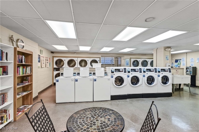 laundry room featuring stacked washer / drying machine, independent washer and dryer, and sink