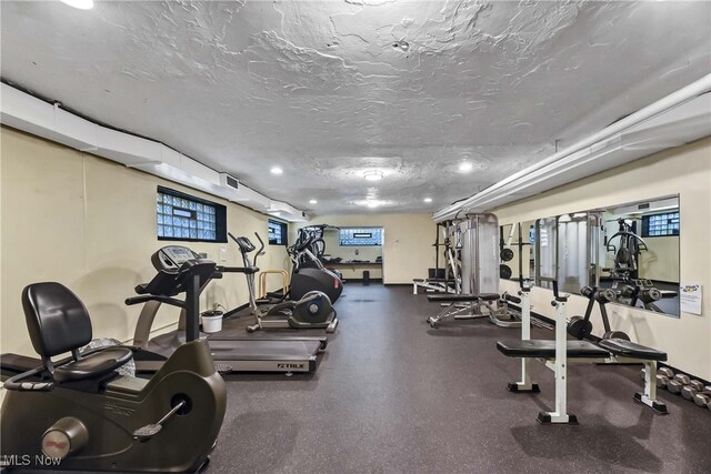 workout area featuring a textured ceiling