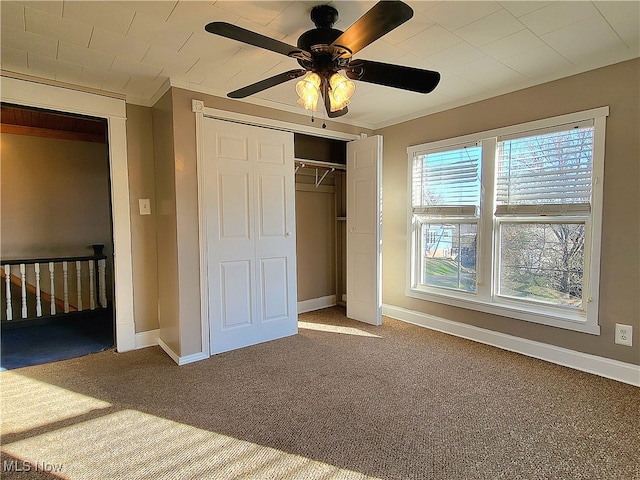 unfurnished bedroom featuring carpet floors and ceiling fan