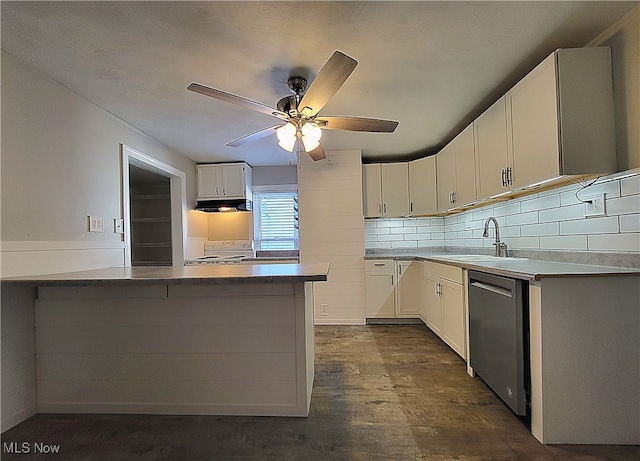 kitchen with sink, stainless steel dishwasher, kitchen peninsula, white cabinets, and range