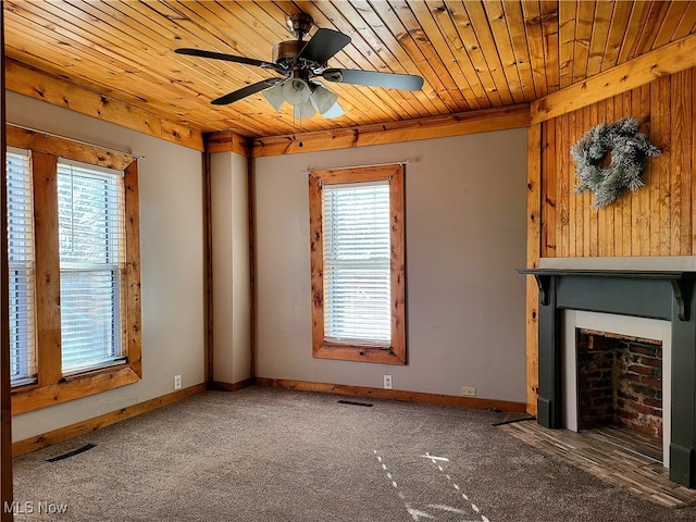 unfurnished living room with dark colored carpet, ceiling fan, and wooden ceiling