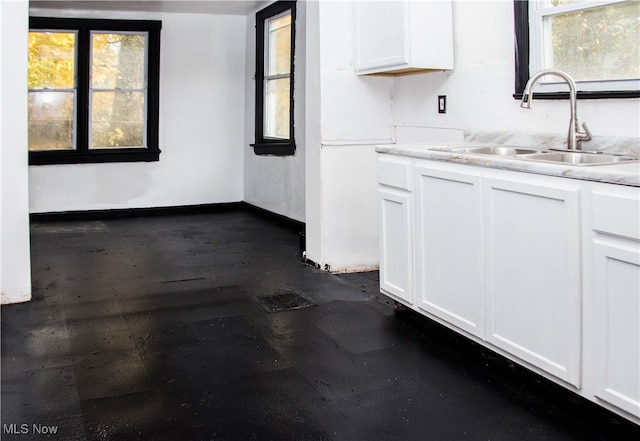 kitchen featuring sink and white cabinets