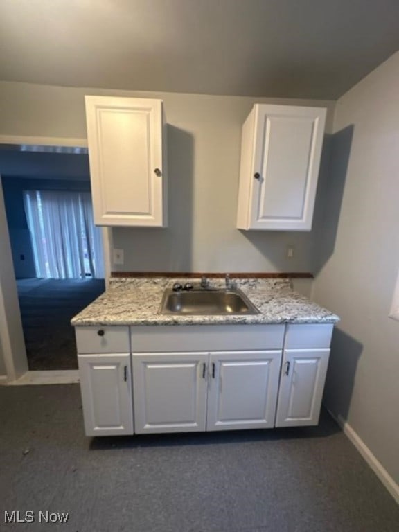 kitchen with white cabinetry and sink