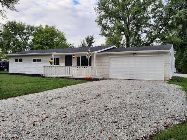 single story home with a front yard, a porch, and a garage