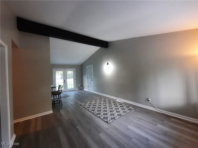 unfurnished living room featuring dark hardwood / wood-style flooring, lofted ceiling with beams, and french doors