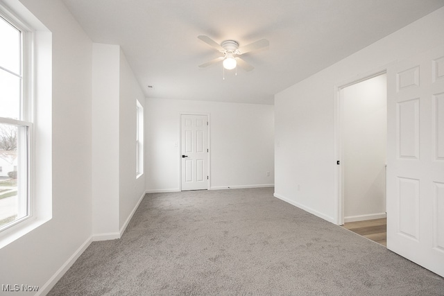 empty room with carpet flooring and ceiling fan