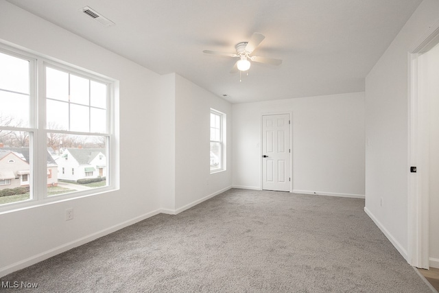 unfurnished room featuring ceiling fan, carpet floors, and a healthy amount of sunlight