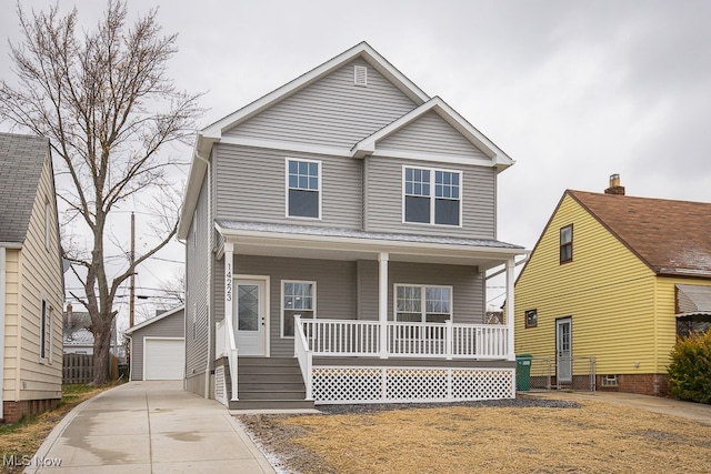 view of front of property featuring an outdoor structure, a porch, and a garage