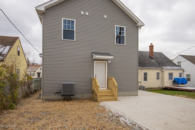 rear view of house with central AC