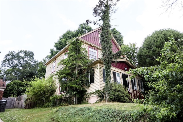 view of side of home with a yard