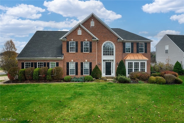 colonial-style house with a front lawn