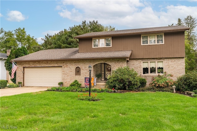 view of front of house with a garage and a front lawn