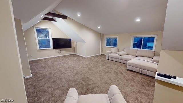 unfurnished living room with carpet floors and lofted ceiling