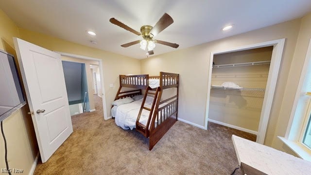 carpeted bedroom featuring a closet and ceiling fan