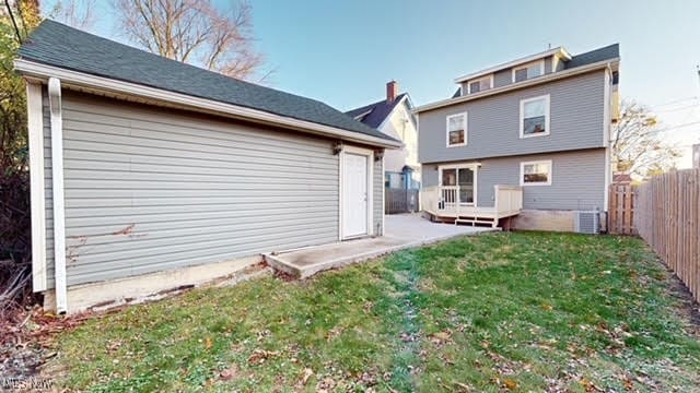 rear view of property with a yard