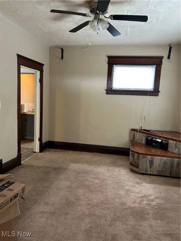 spare room with ceiling fan and a textured ceiling