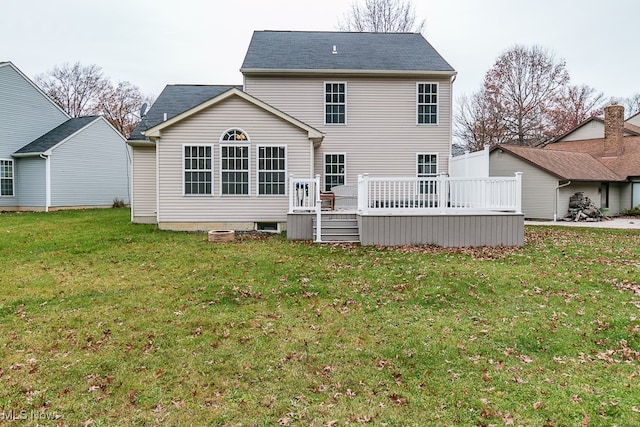 back of house with a lawn and a wooden deck