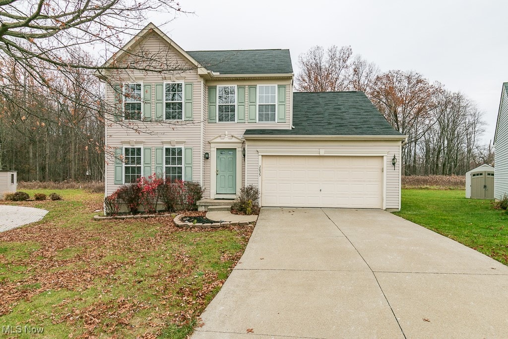 view of front of property featuring a garage and a front yard