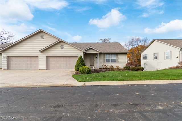 ranch-style house featuring a front lawn and a garage