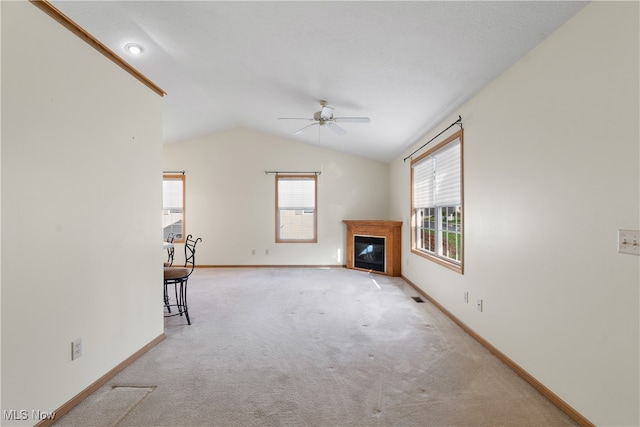 unfurnished living room featuring ceiling fan, light carpet, and vaulted ceiling